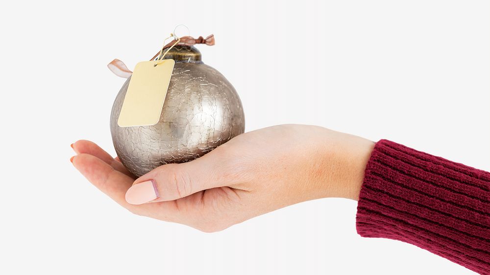 Hand presenting bauble isolated image