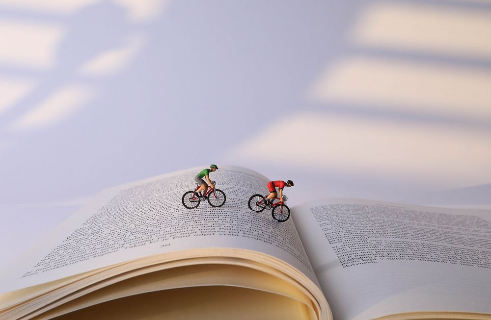 Book cyclists, miniature sport advertising.