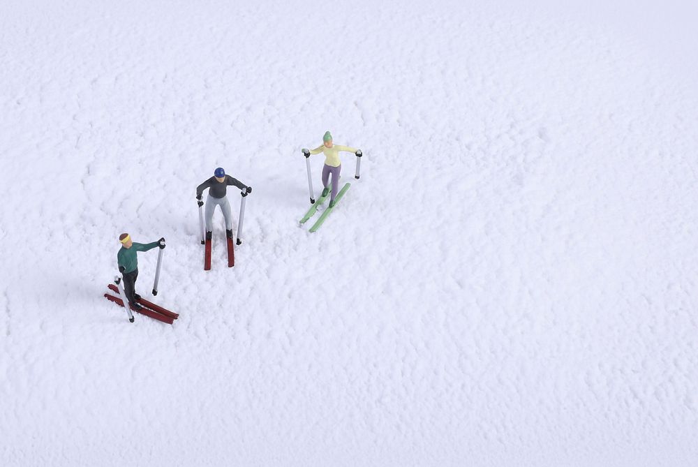 Miniature snow skiers, sport advertising.