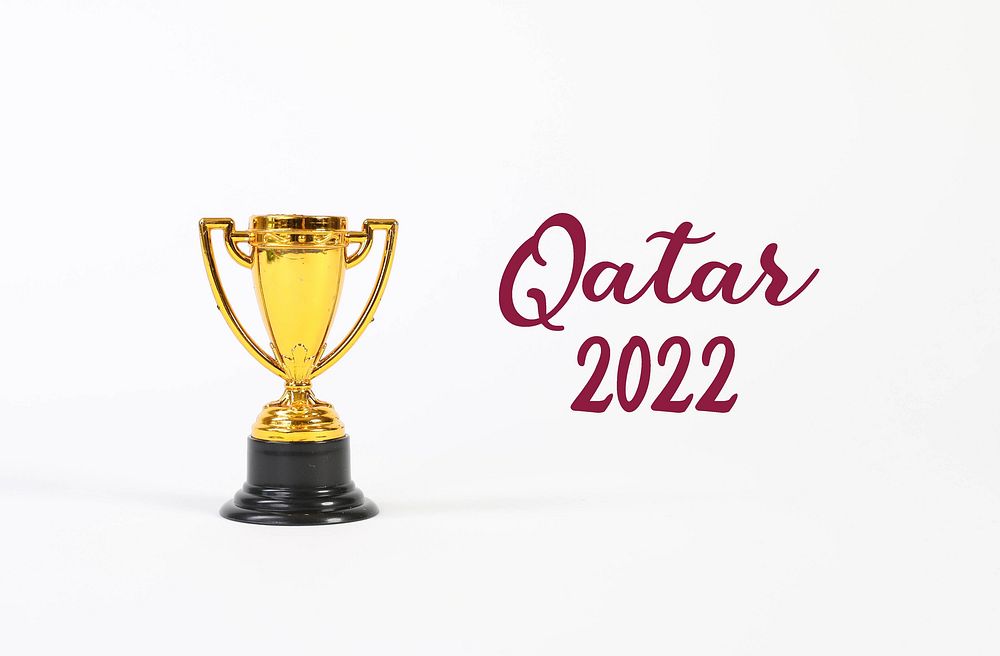 Golden trophy with Qatar 2022 text on white background 