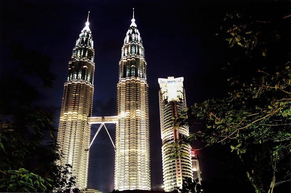 Petronas & Maxis NightviewEvening shot of the twin Petronas Towers and little brother Maxis Tower 212m, Kuala Lumpur…