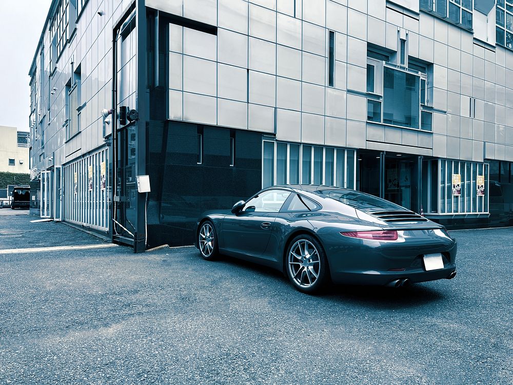 Grey Sports Car, Tokyo, JapanOn a gloomy overcast day, a grey sports car is parked outside a building in Ikenohata, Taito…
