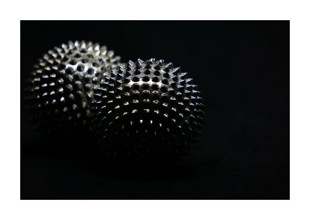 Spiked metallic balls, dark aesthetic.