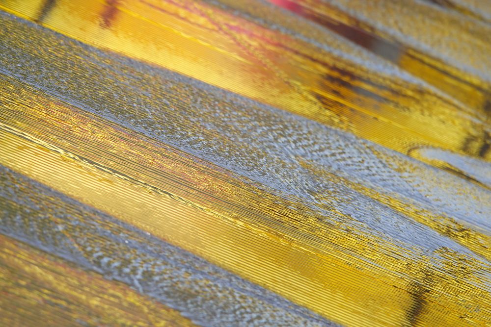 Shiny gold texture artwork close up shot.