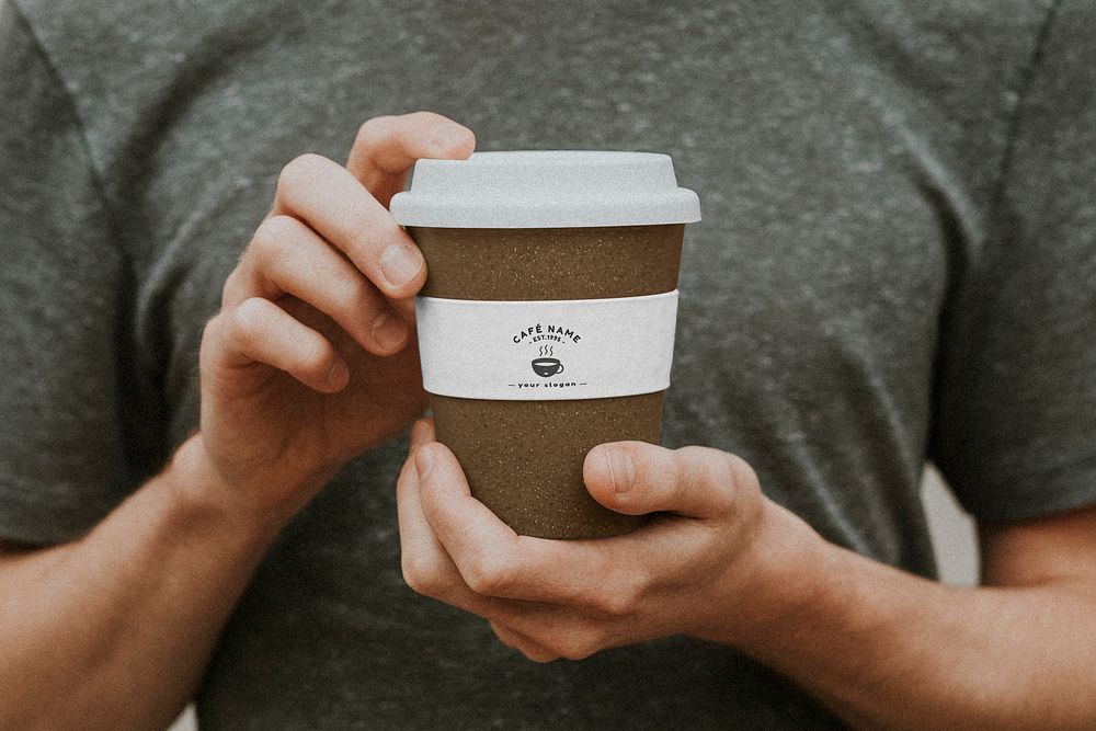 Man holding a brown paper cup