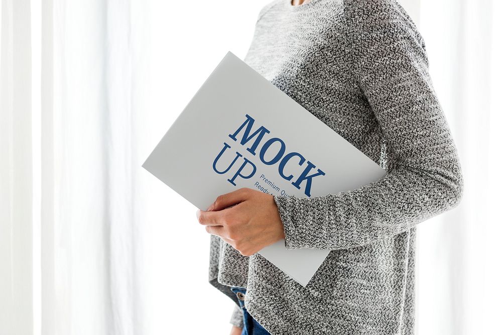 Woman in a gray top holding a board mockup