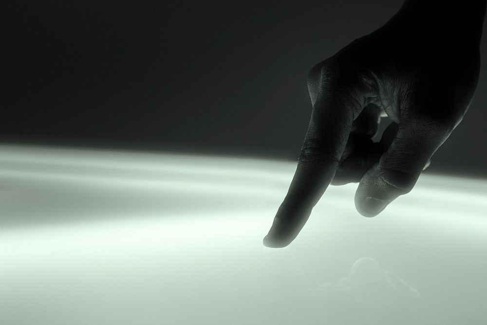 Hand touching screen, digital remix