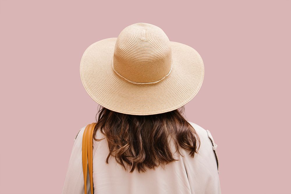 Woman tourist wearing sun hat rear view