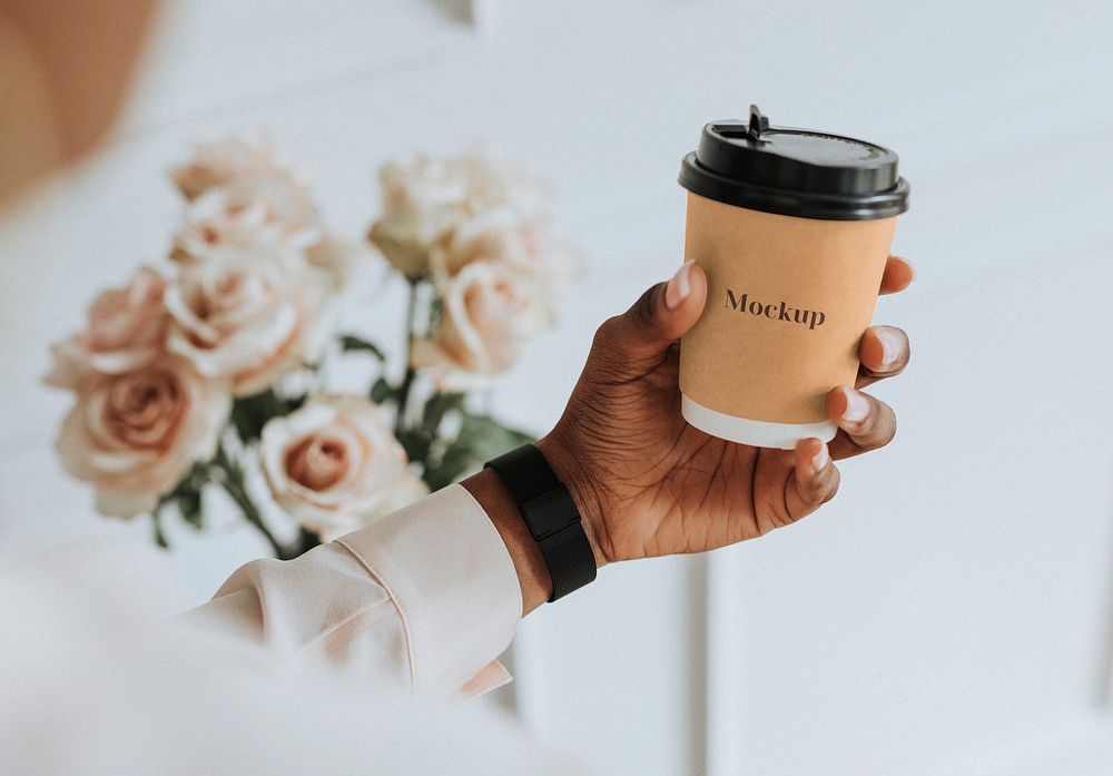 Black woman holding a paper coffee cup mockup