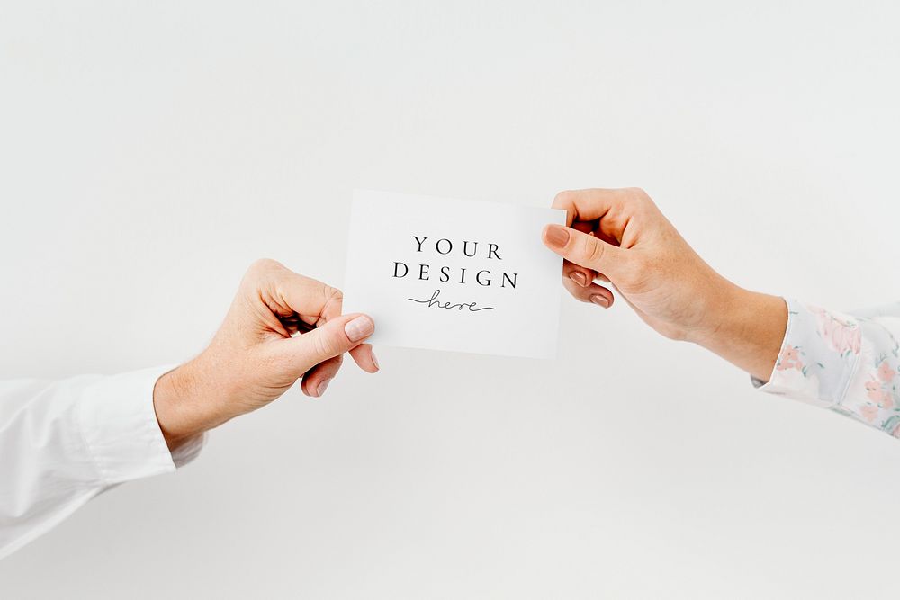 Hands holding a white card mockup