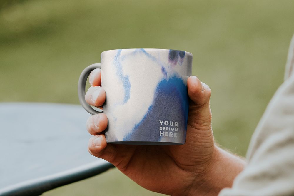 Mug mockup psd being hold by a person
