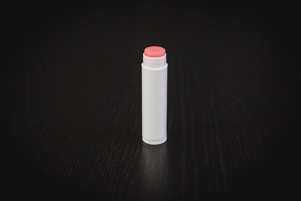 White tube of homemade light pink lip balm.