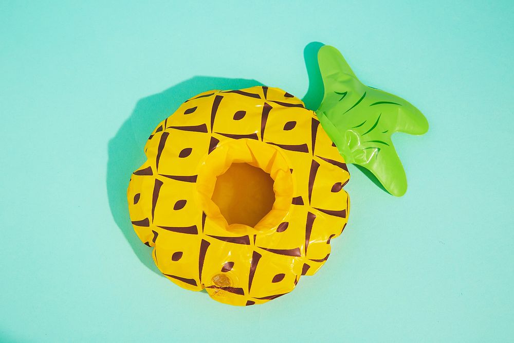 Blow-up pineapple drink holder and toy for pool or beach.