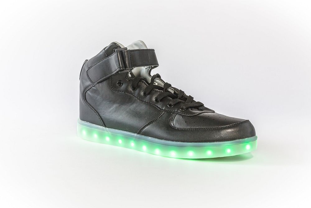 Black shoe with green LED lights around the sole.