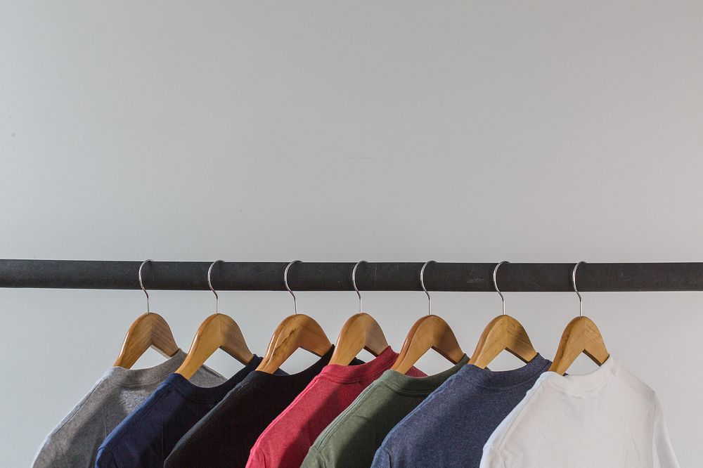 Blank tshirts hanging wooden hangers. Free Photo rawpixel