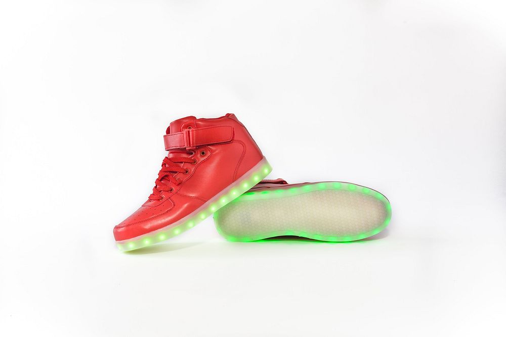 One pair of red high top shoes with green LED light.