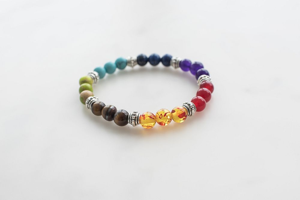 Closeup of chakra bracelet on marble beads.