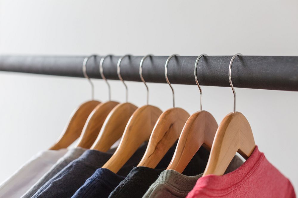 Wooden hangers with t-shirts