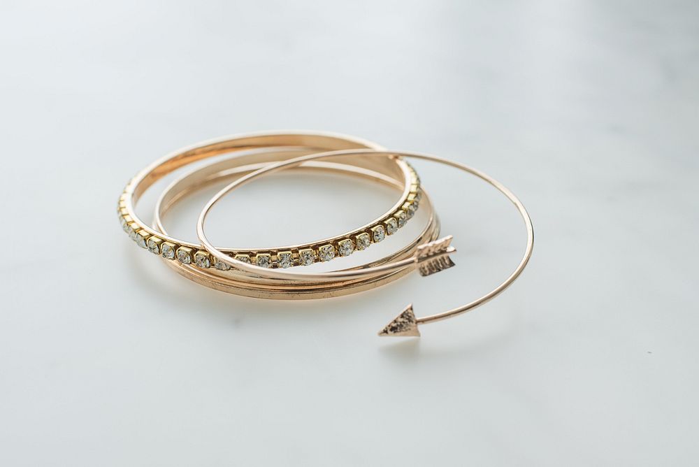 Gold bangle bracelets, fashion accessory.