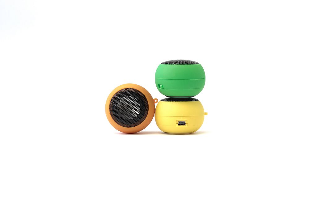 Three different color mini plug in speakers.