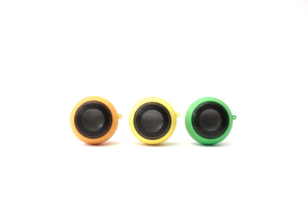 Front view of three different color plug in speakers.