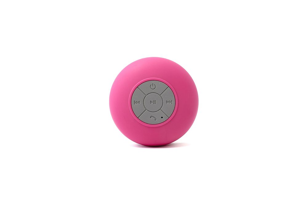 Front view of pink waterproof speaker on glass.