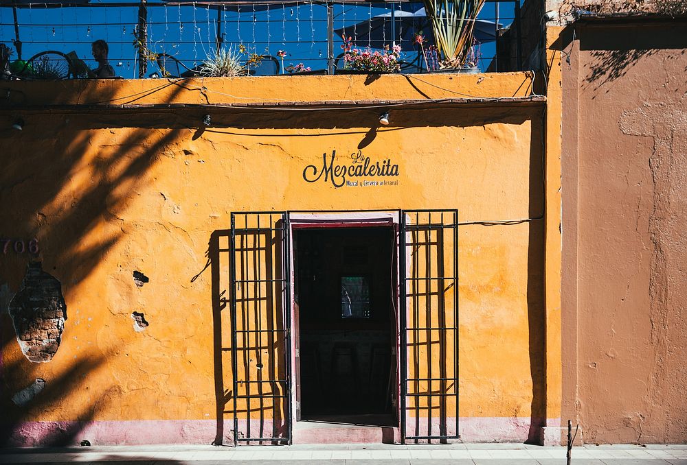 Exterior of a small yellow building with a bar inside. The name of the establishment above the door tells us it's a Mexican…