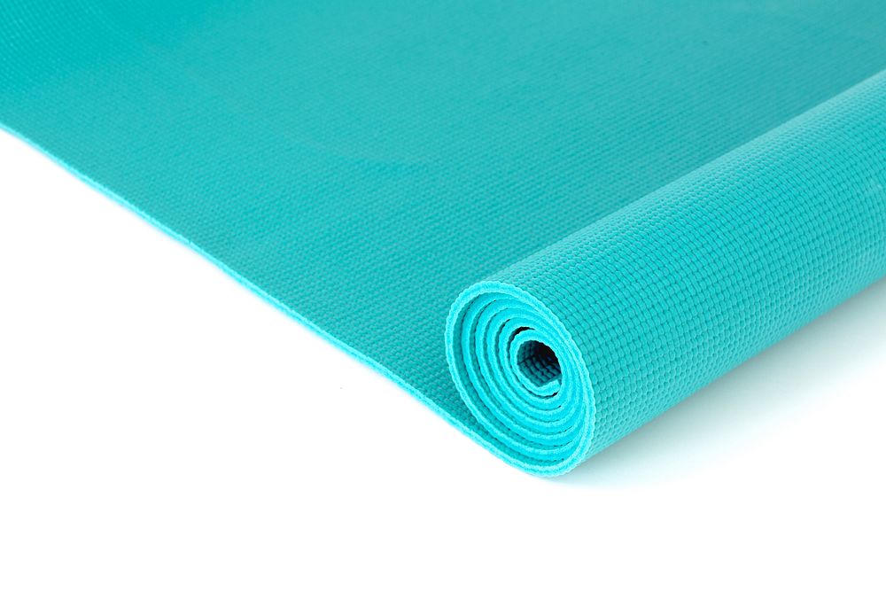 Close up of unrolled yoga mat.