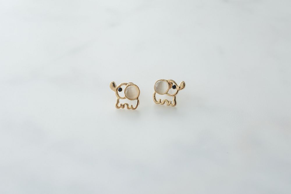 One set of small gold elephant earrings.