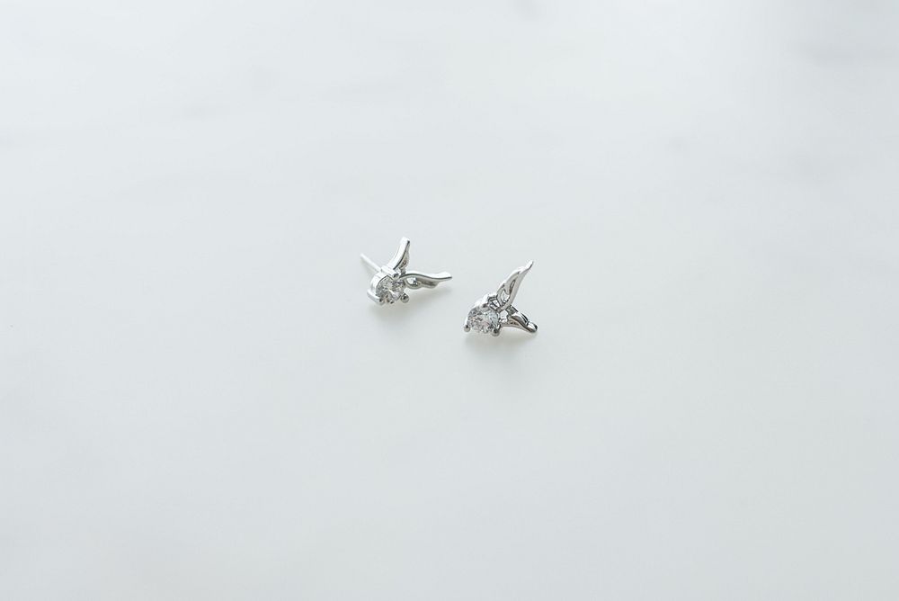 Silver guardian angel earrings with diamond gemstones.