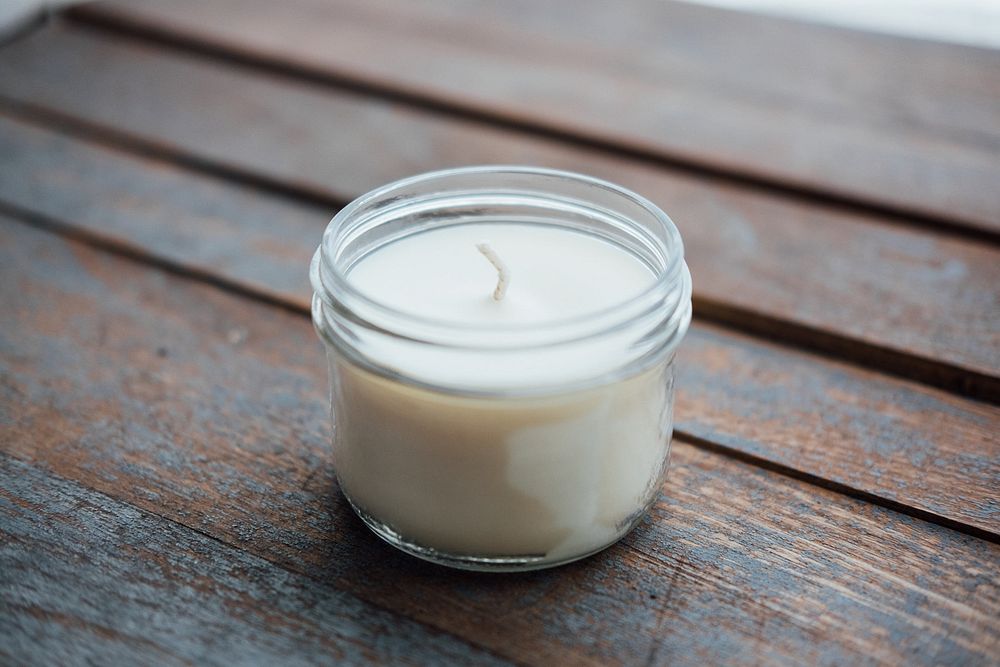 Homemade soy candle, wooden table.