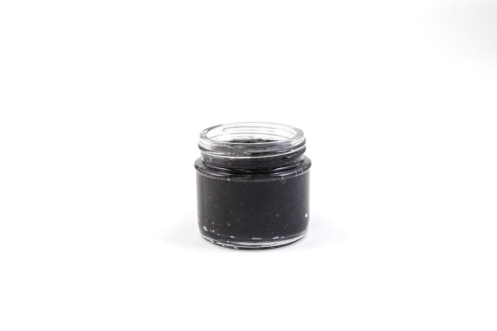 Small container of activated charcoal mask.