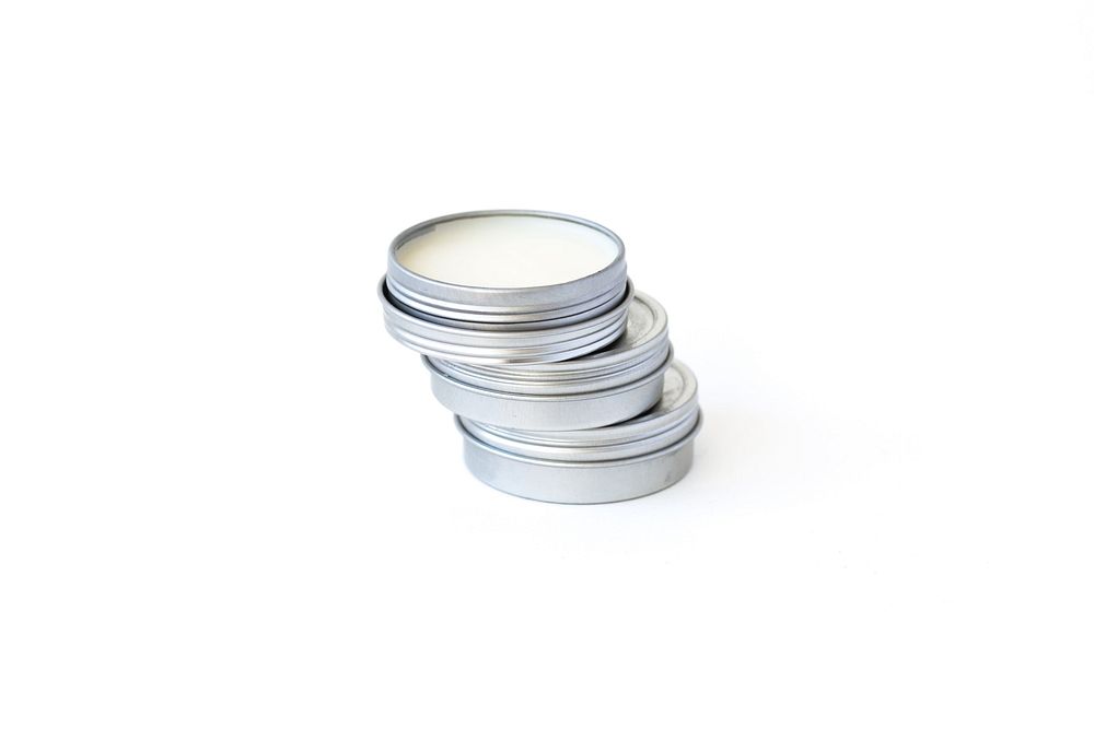 Stack of three beard balms in round silver tins.