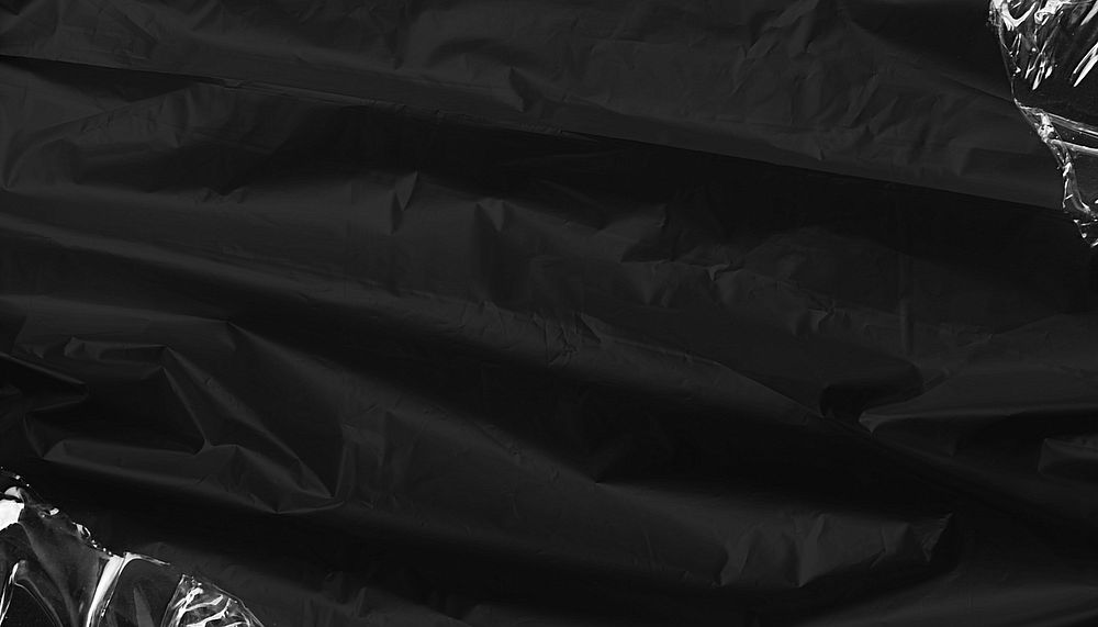 Black textured plastic wrap background, border design