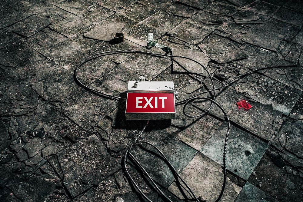 Abandoned building with exit sign on the floor