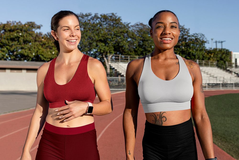 Sports bra and shorts mockup psd on athletic runner friends talking and walking on the track