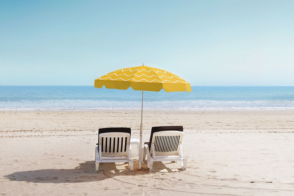 Beach chairs with yellow umbrella