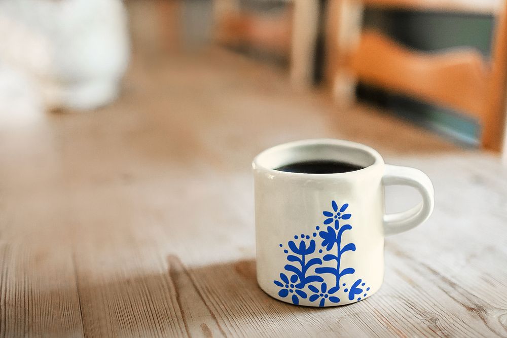 Blue floral coffee mug on wooden table