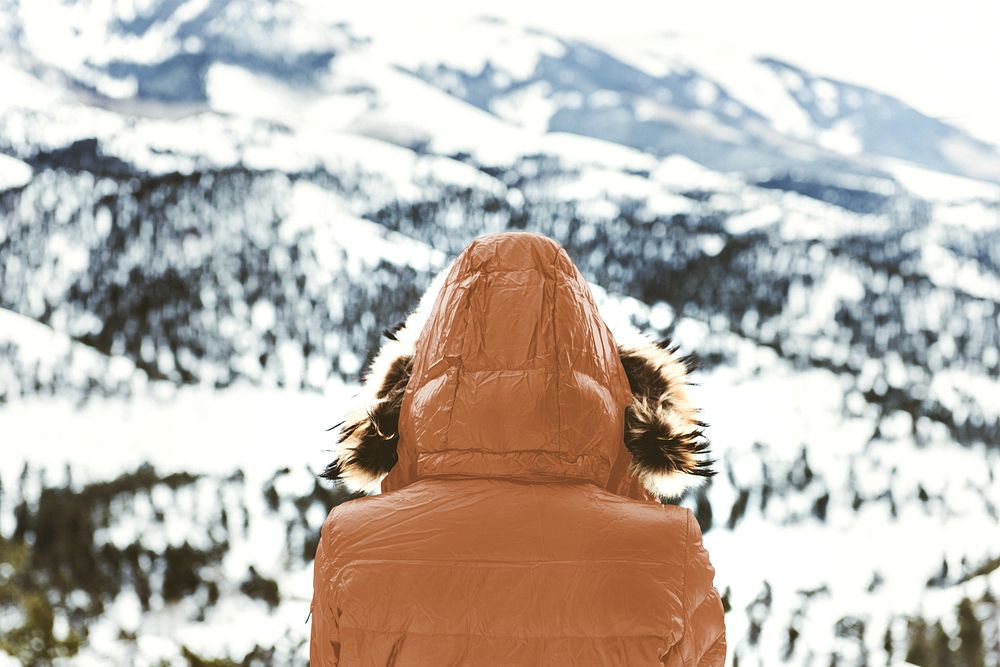 Woman in brown puffer jacket at ski resort