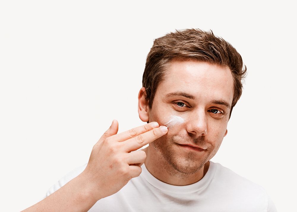 Man applying facial cream isolated image