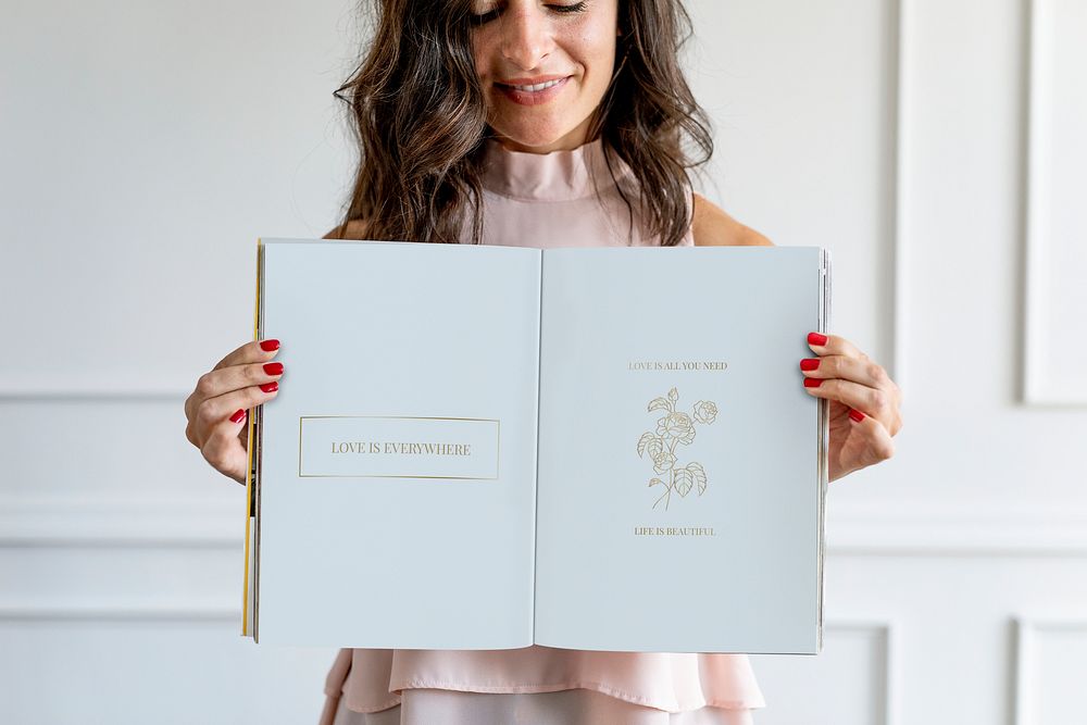 Happy woman holding a floral love text book mockup