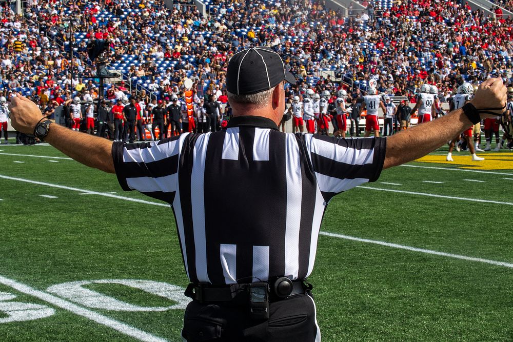 Referee, American football game, stadium. Original public domain image from Flickr