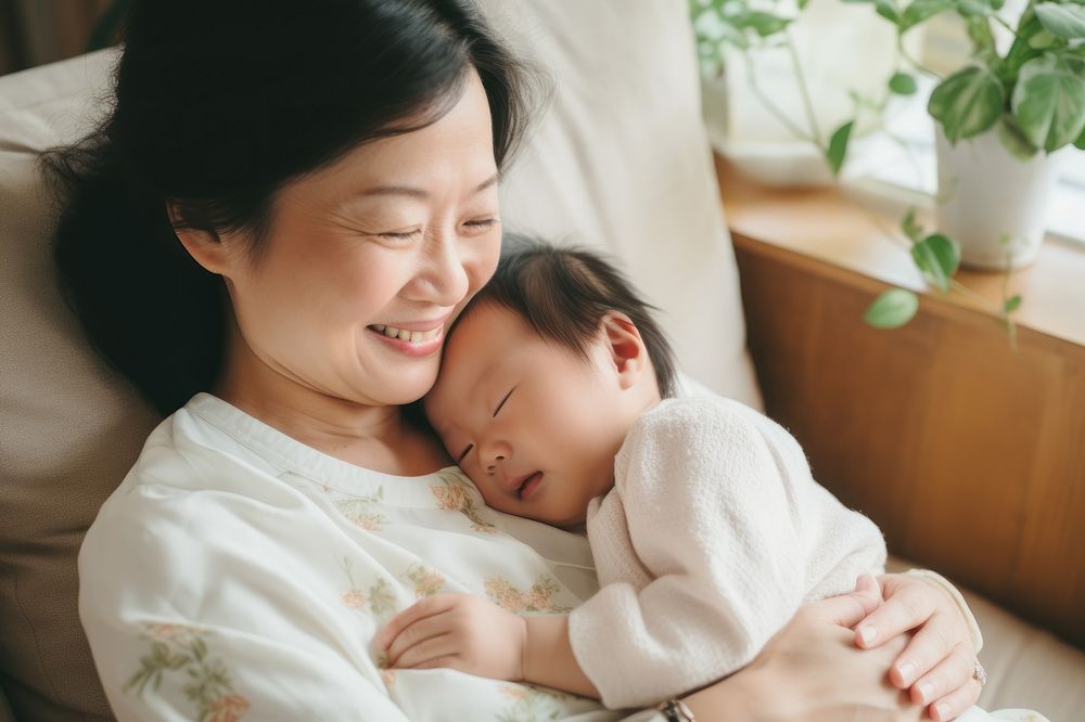 Asian baby sleeping on mom's chest AI generated image
