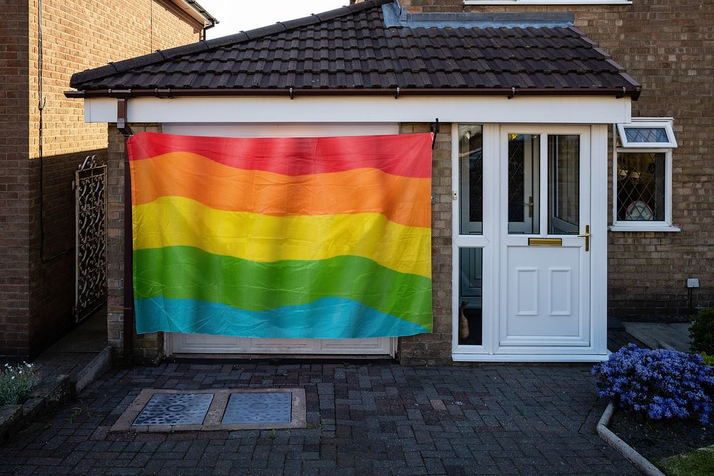 LGBTQ pride flag in front of a house