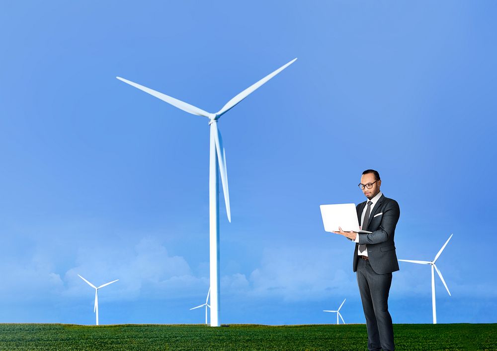 Wind turbine background, businessman using laptop image