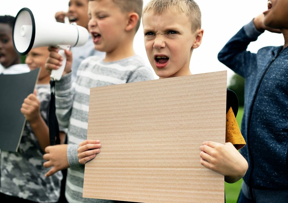 Protesting boy holding blank sign
