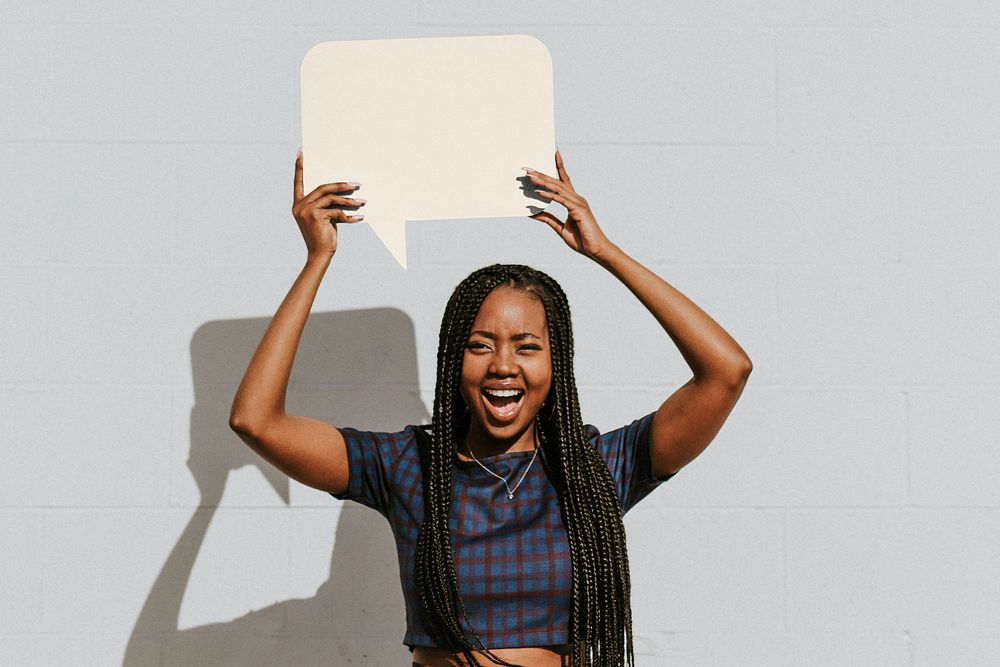 Black woman holding blank speech bubble sign
