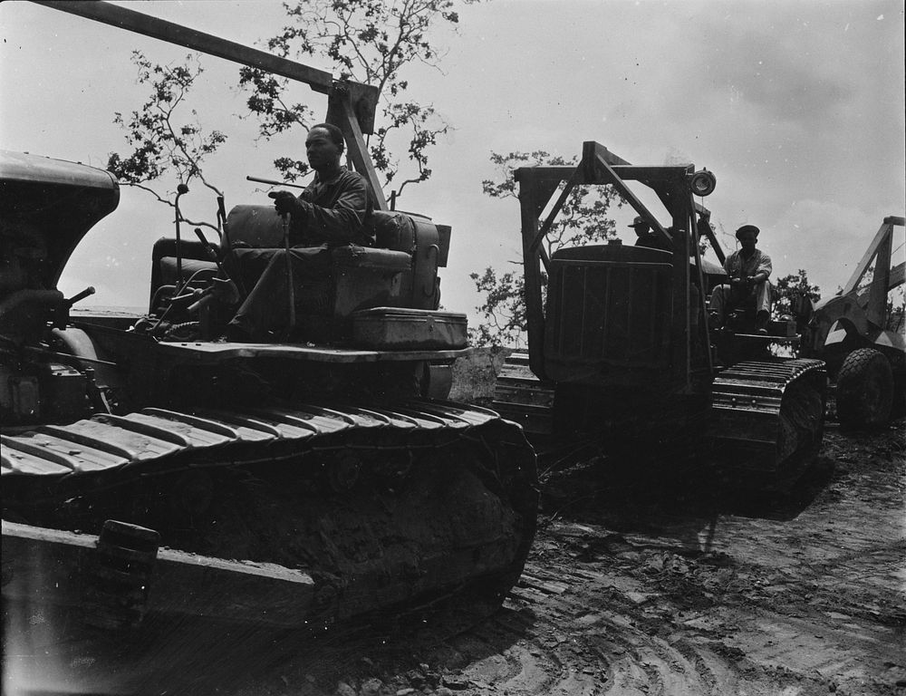U.S. African American troops in New Guinea. Heavy equipment "brigade" of a African American engineer unit. Here technical…