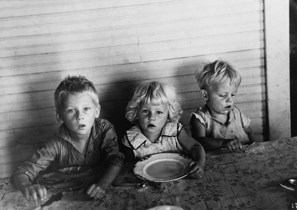 Children of Olaf Fugelberg waiting for dinner. Williams County, North Dakota by Russell Lee