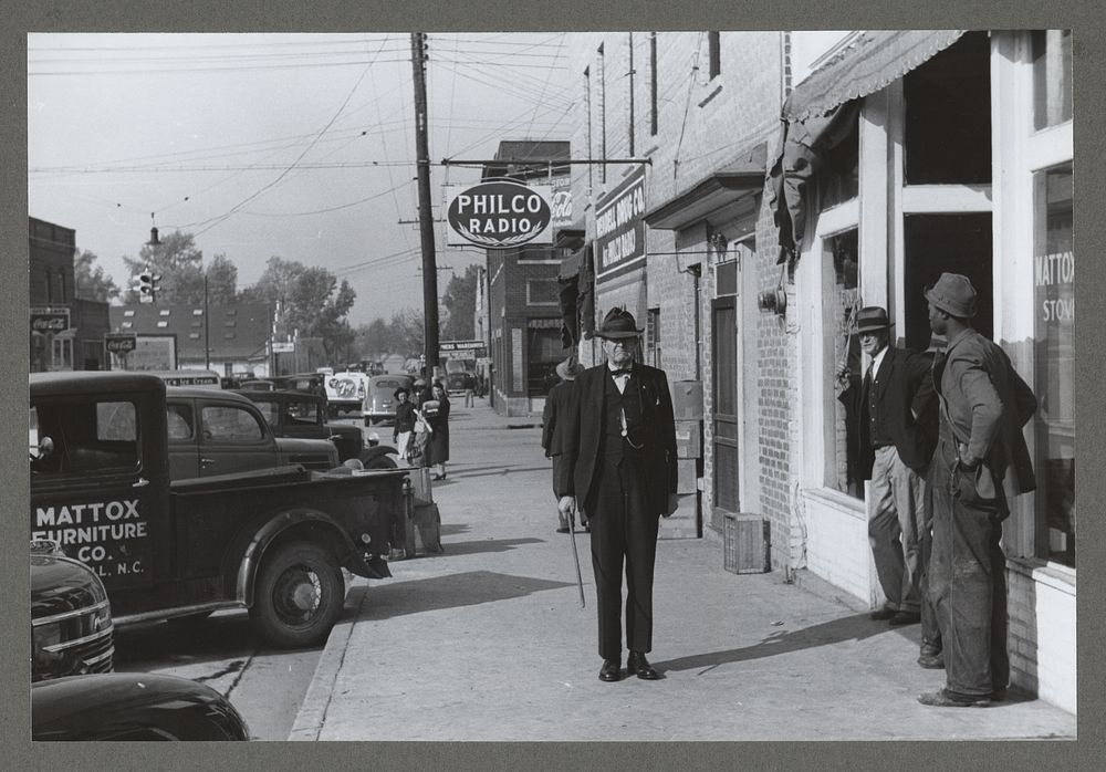 R.B. Whitley, who is president of the bank and one of the leading citizens of the town, walking down the steet of Wendell…